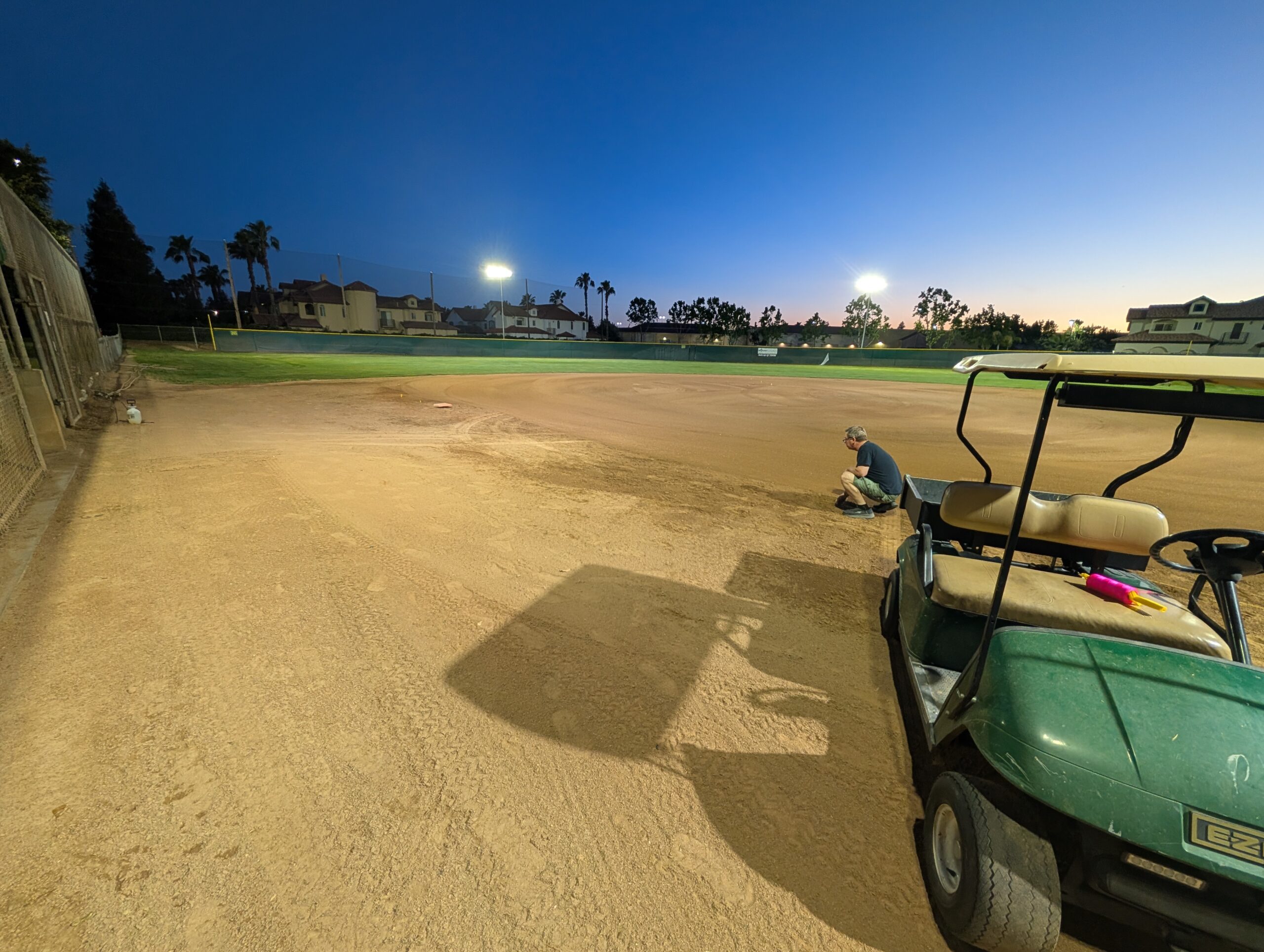 Baseball field outfield under new LED sports lighting at dusk Fresno CA